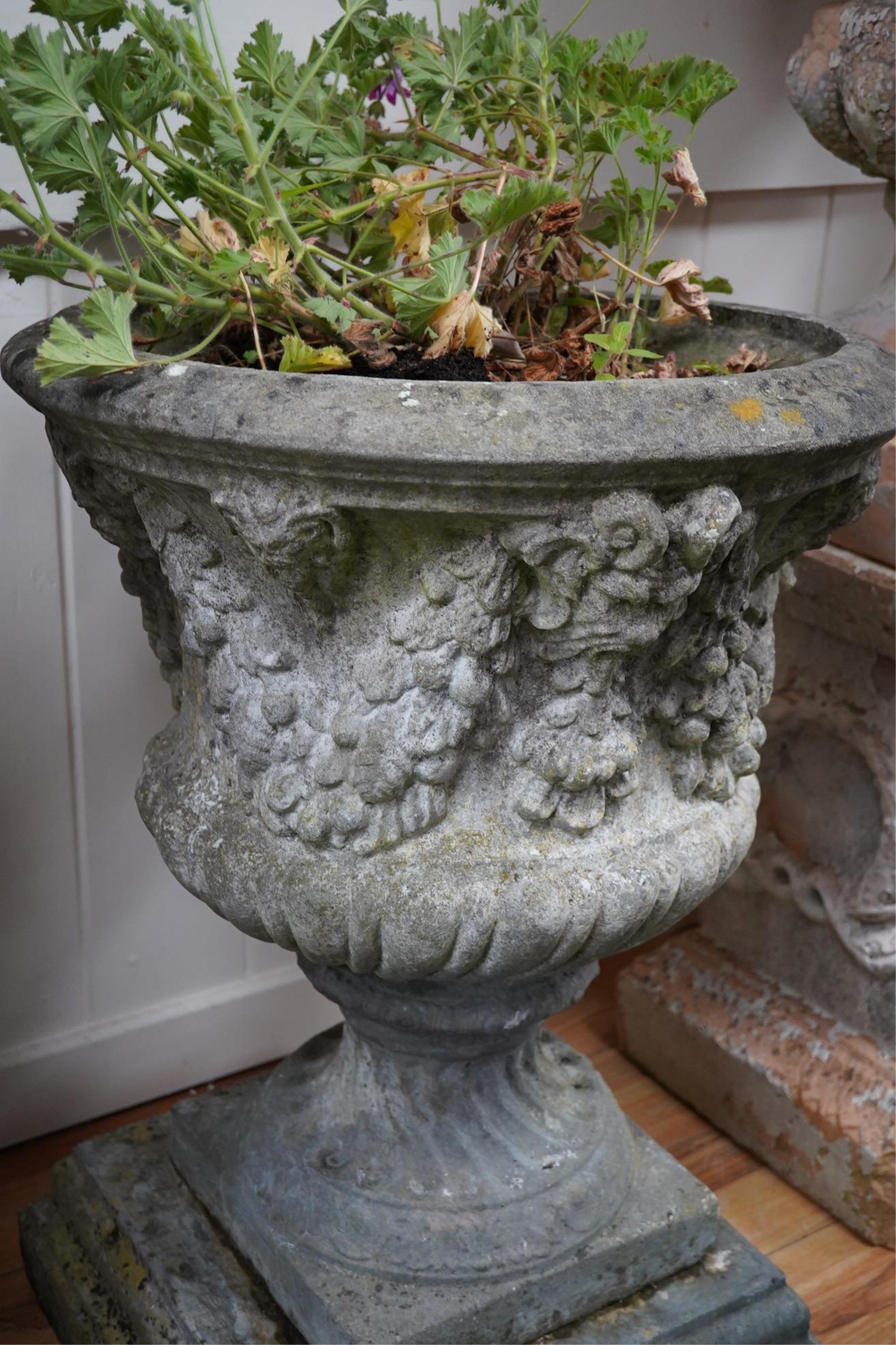 Three reconstituted stone campana shaped garden urns